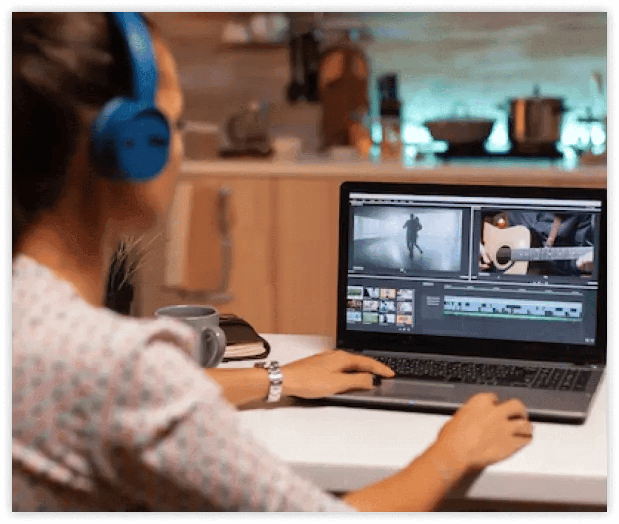 A video editor edits a video on a computer with headphones on her head.